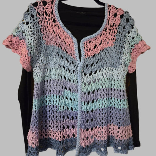 Multi-colored short sleeve summer cardigan layered over black long sleeve tee
