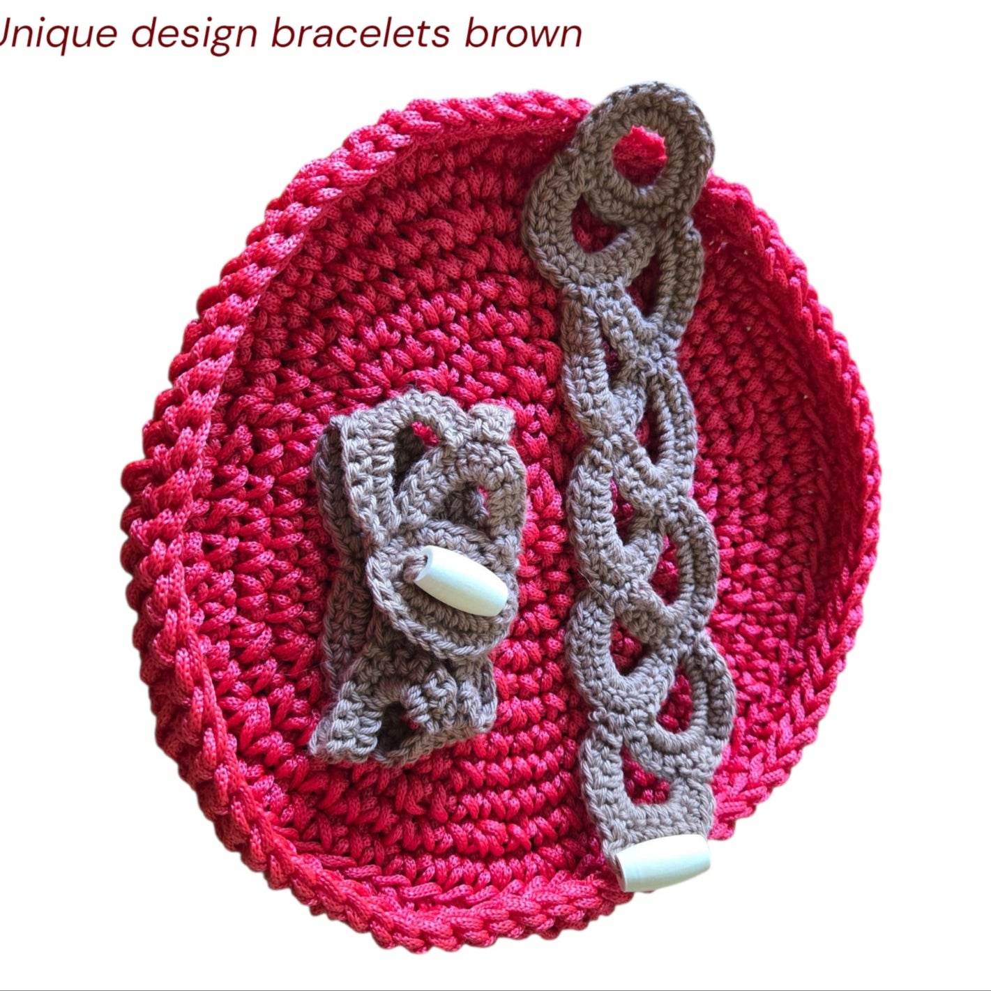 Crocheted vintage brown cotton yarn bracelets with button closures on red crocheted background
