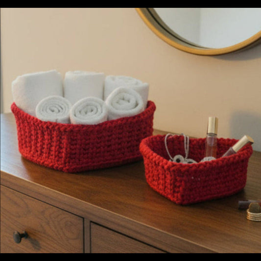Two heart shaped baskets in color red sold as a set with a wood base.