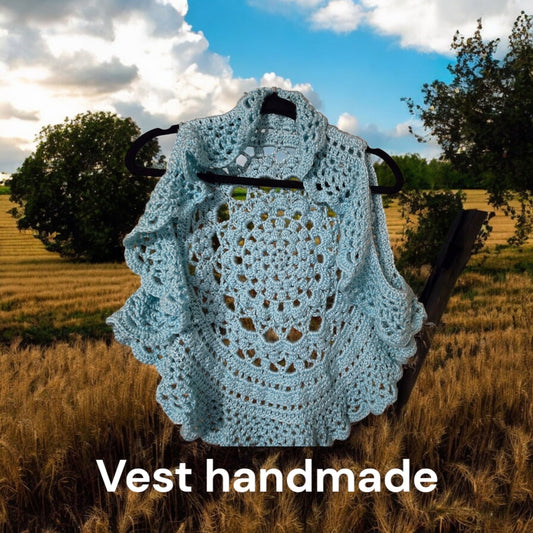 Unique design handmade crocheted vest displayed outdoors.