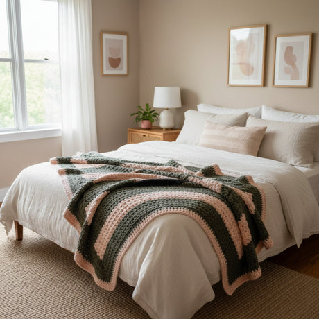Crocheted stitch by stitch in a harmonious palette of gray and pink, this 34" x 26" throw embodies the quiet luxury of slow-made textiles. Made by Stitched Creations