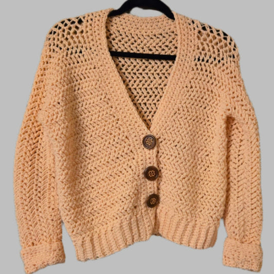 Peach colored cardigan with buttons crop style.