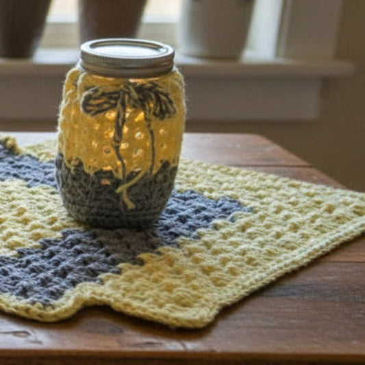 Handcrafted yellow and gray crocheted cotton table runner with two mason jar tea light holders