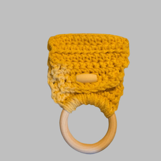yellow dish towel holder with wooden ring and button closure for kitchen organization
