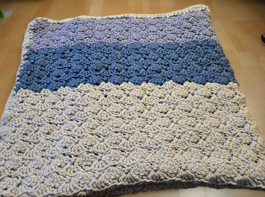 Handmade multicolored blue baby blanket with soft yarn and textured pattern