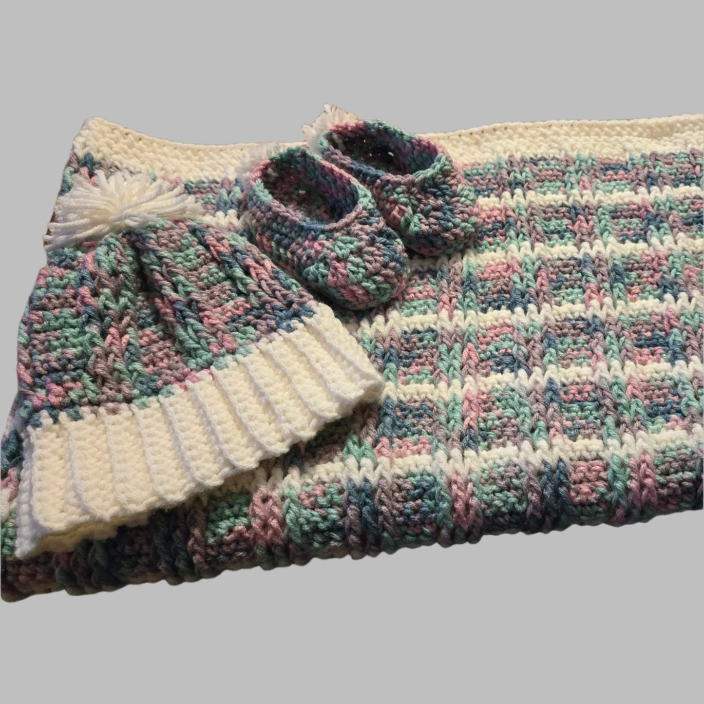 Handmade multicolored baby blanket set with matching hat and slippers