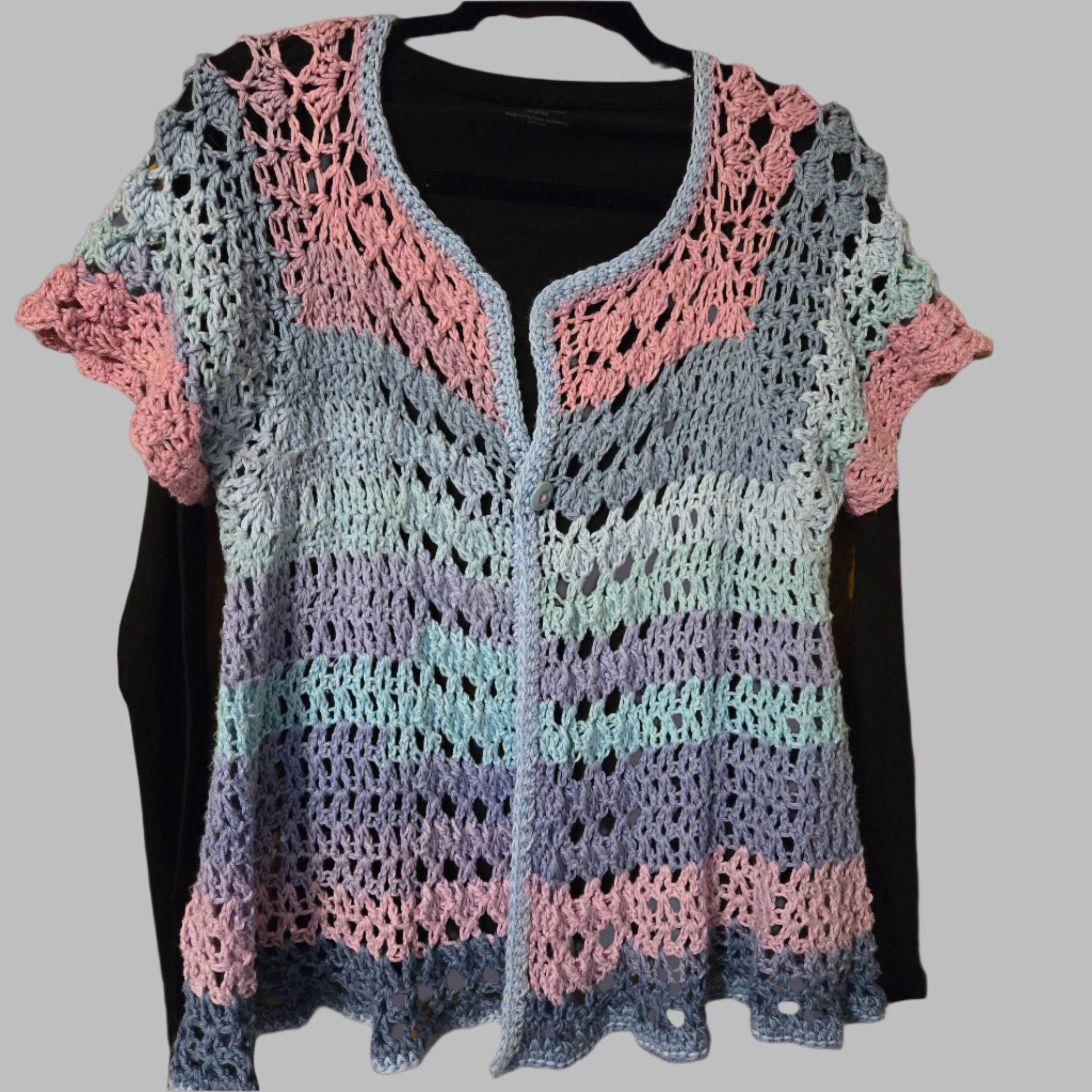 Short sleeve summer cardigan in pinks and blues over black long sleeve tee.