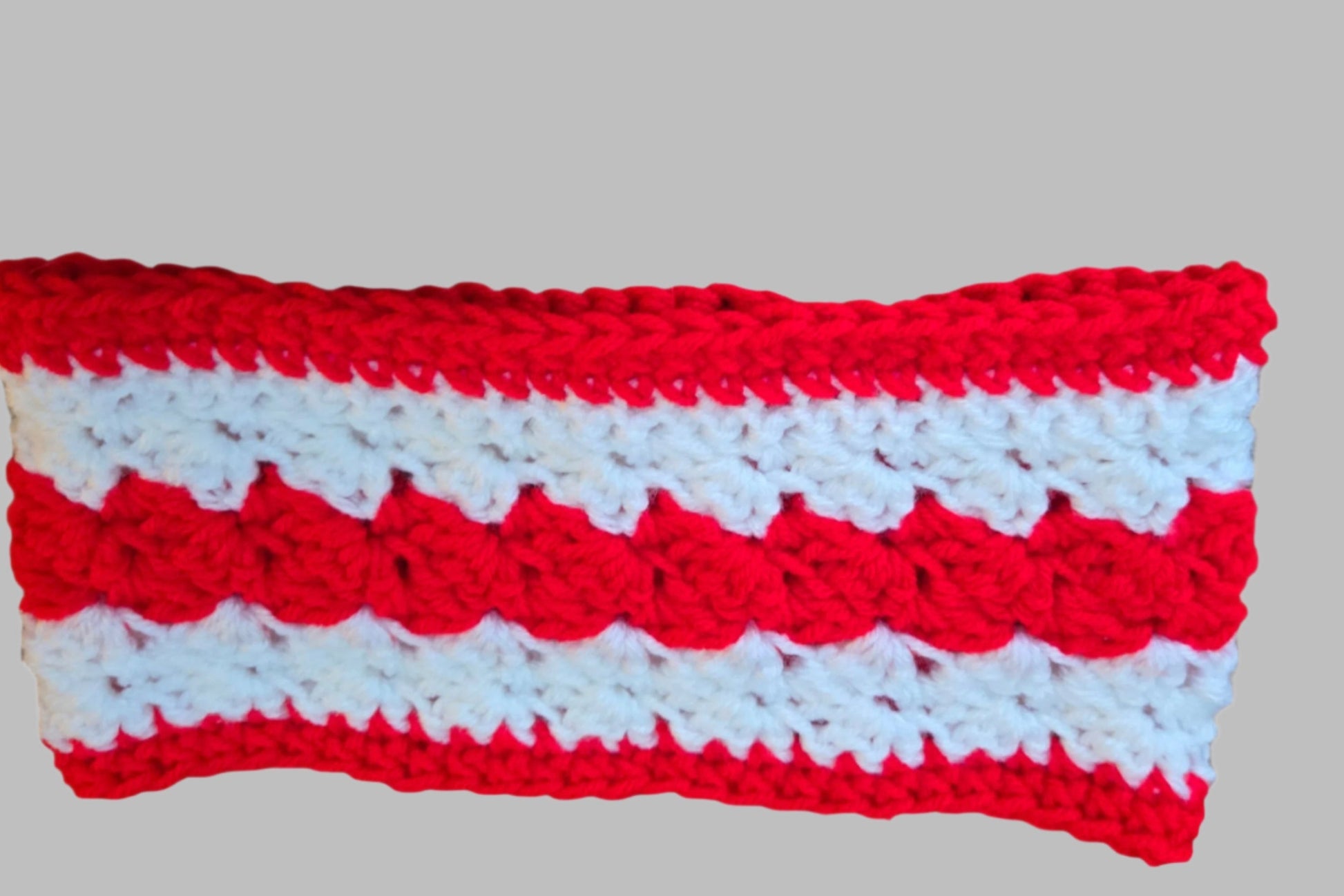 Red and white handmade winter head band for stylish warmth.