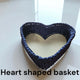 Blue heart shape handmade basket made of macrame cord on white surface