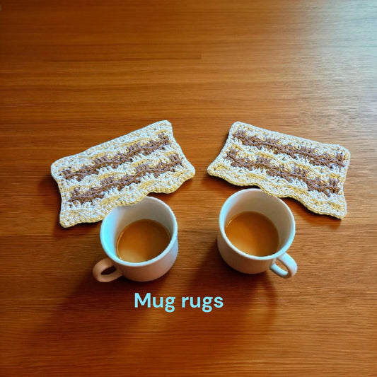 Handmade cotton mug rugs in brown and cream colors with two coffee cups on wooden surface