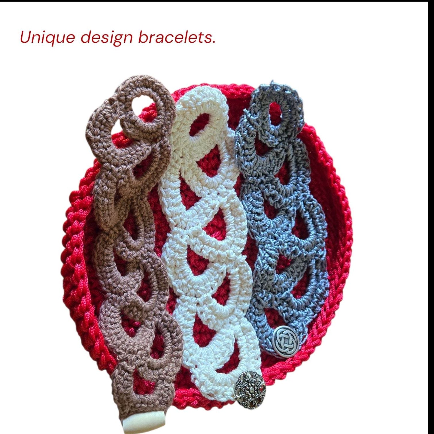 Crocheted vintage bracelets in brown, white, and gray with button closures on a red round mat