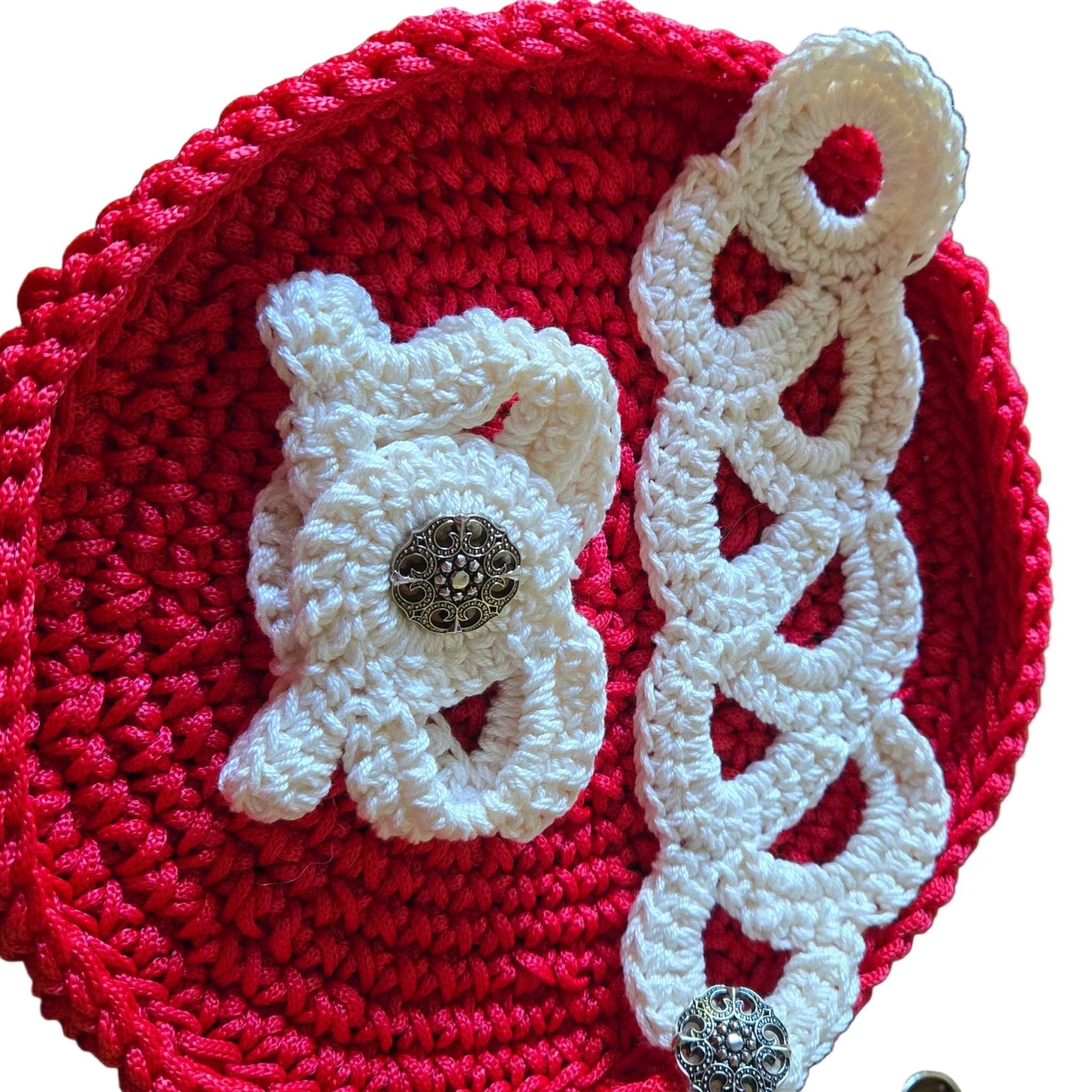 White crocheted vintage bracelets with button closures on red crochet background