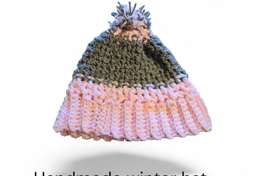 Handmade winter hat gray and pink in color with a pom pom