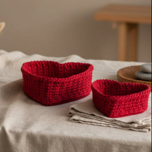 Two heart shaped baskets color red sold as a set with a wooden base.