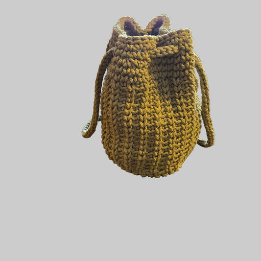 Handmade bucket purse in beige.  Made from 100% cotton macrame cord.  Has vinyl base .   9 x 7.5