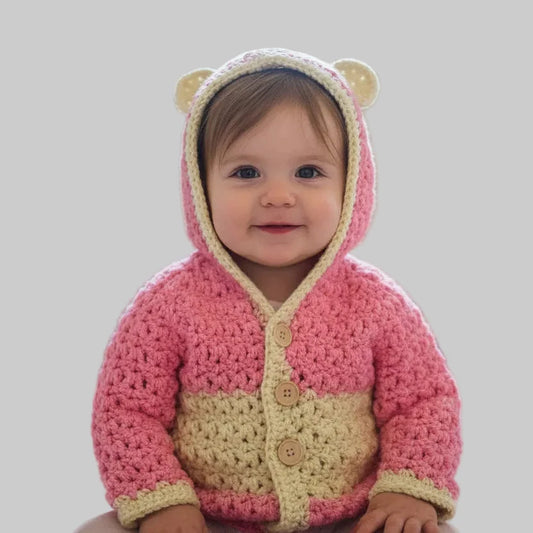Handmade baby sweater colors  pink and cream.  Has hood with ears and three button closure.  size 6-12 months