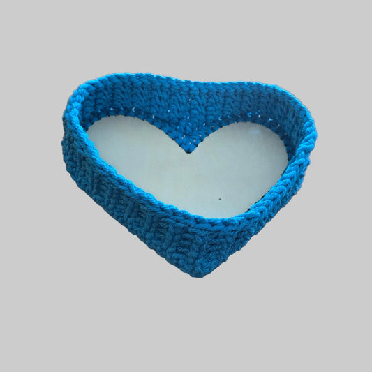Handmade heart shaped basket made from macrame cord with a wood bottom.  Color summer blue and measures 8 x 10.