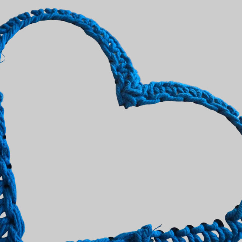 Heart shaped basket showing bottom of basket with wood base.