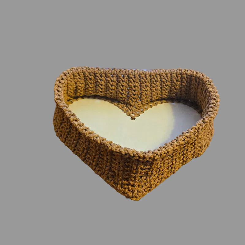 Handmade heart shaped basket measures 8 x 12 and 3 inch depth.  Color tan made from macrame cord.