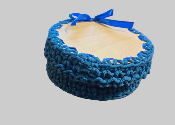 Handmade gift box in color blue with a ribbon on top.  Made from macrame cord inside gift box is a handmade pair of blue booties.  Size newborn- 3 months.