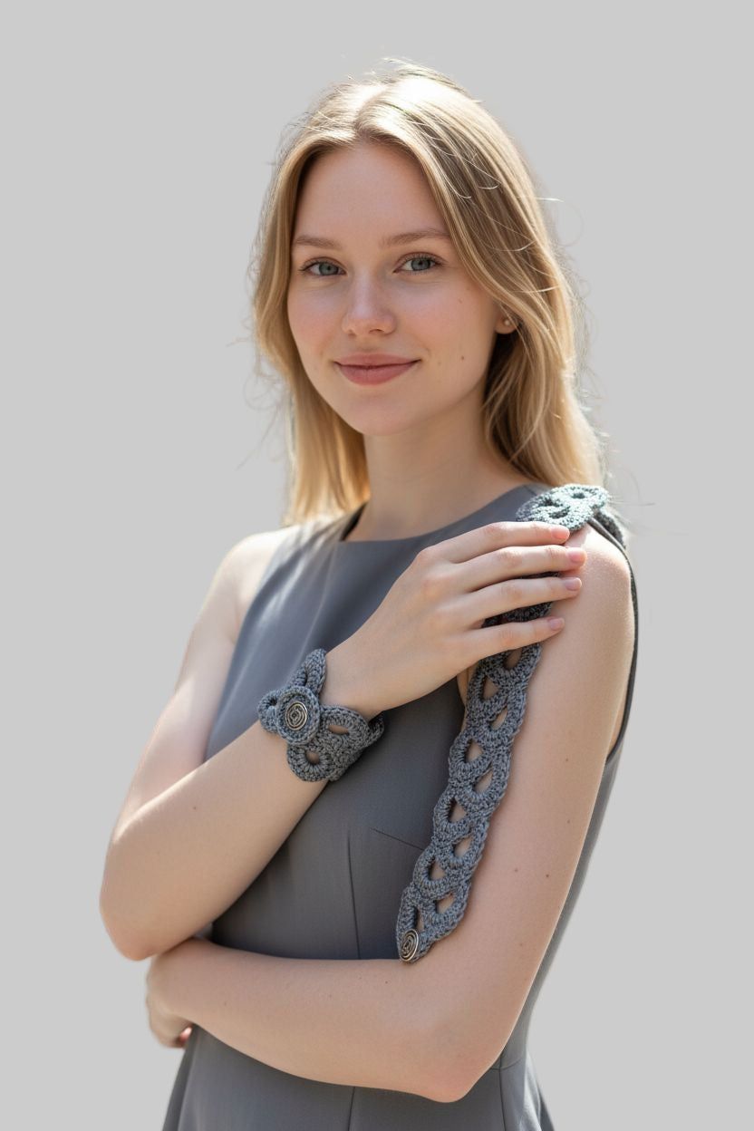 Woman wearing gray crocheted vintage bracelet with button closure on wrist
