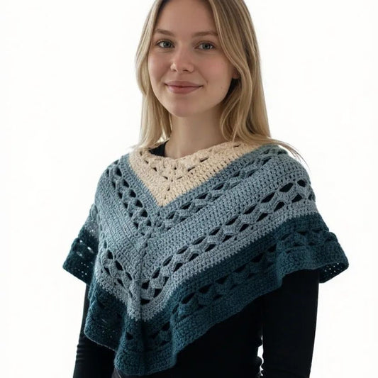 Woman wearing a shawl in cream, two colors of green. 