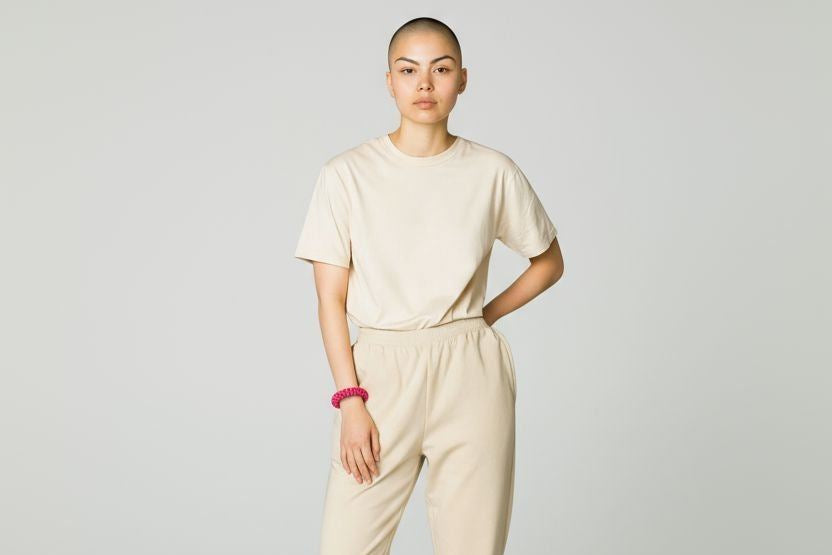 Woman wearing beige outfit and handmade red bangle bracelet