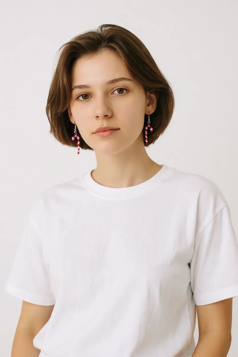 Woman wearing fun holiday Christmas earrings with red and white beads