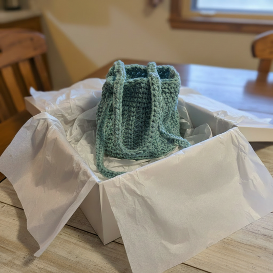 Handmade bucket purse for girls measures 5 x 5 , has a vinyl base.  Made from 100 % macrame cord.