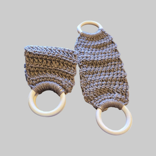 Handmade decorative towel holder with brown knitted fabric and wooden rings for kitchen or camping use