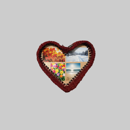 Heart-shaped photo frame with burgundy crochet border holding four photos of nature scenes